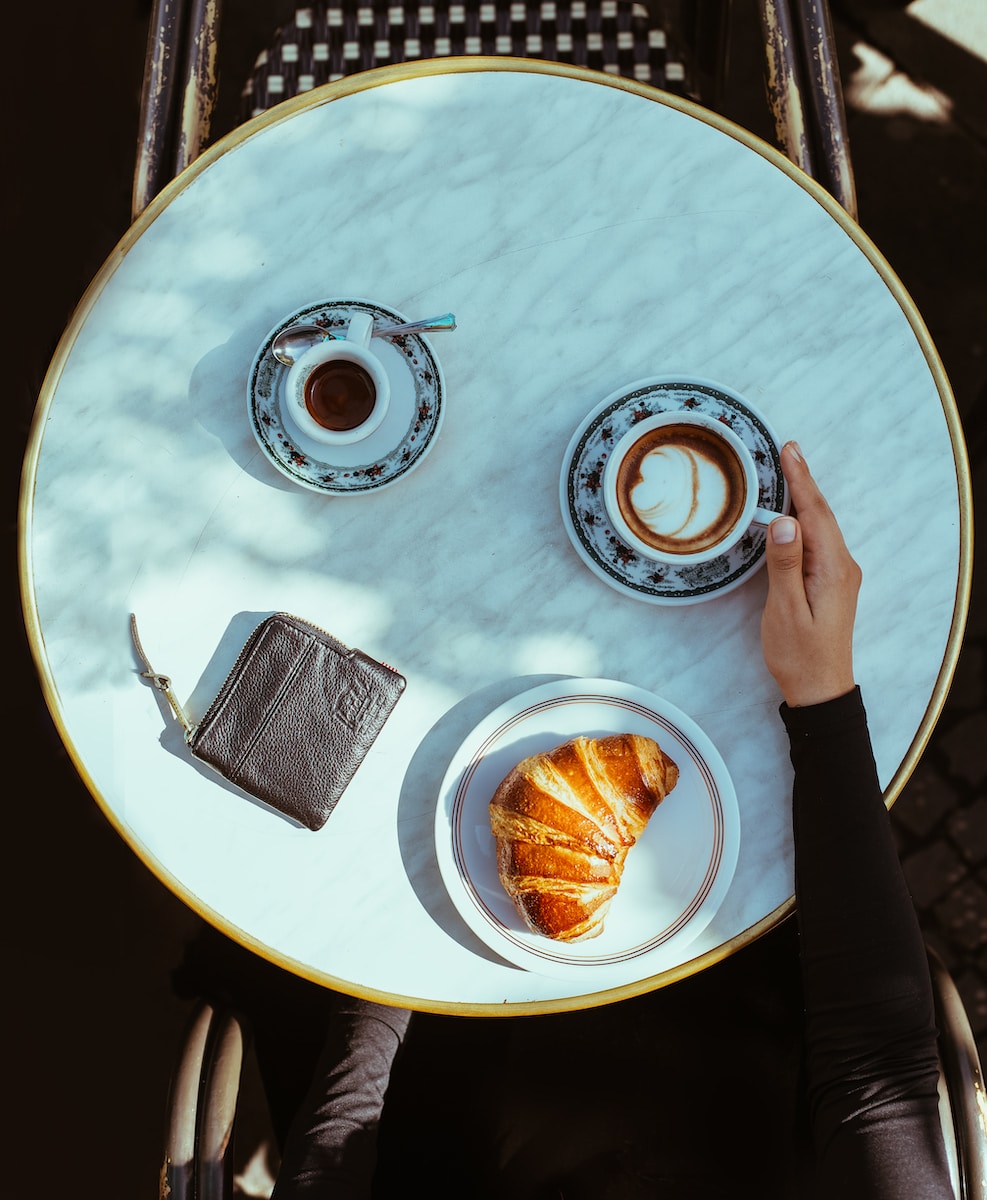 a person holding a plate with food on it