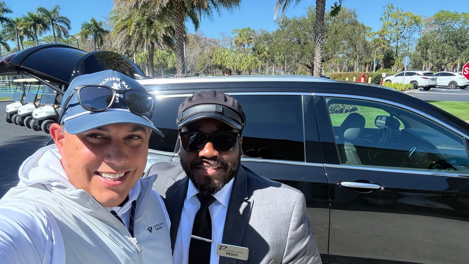 A Private Independent Car Services client with our chauffeur beside a Cadillac in Naples