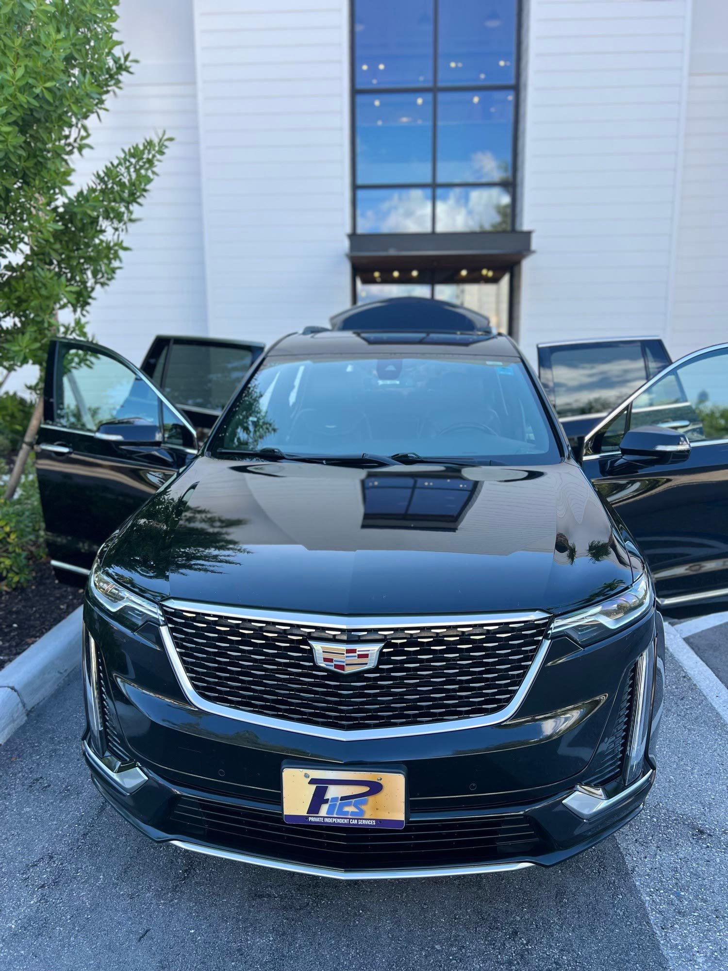 Cadillac SUV with doors open outside a Naples home